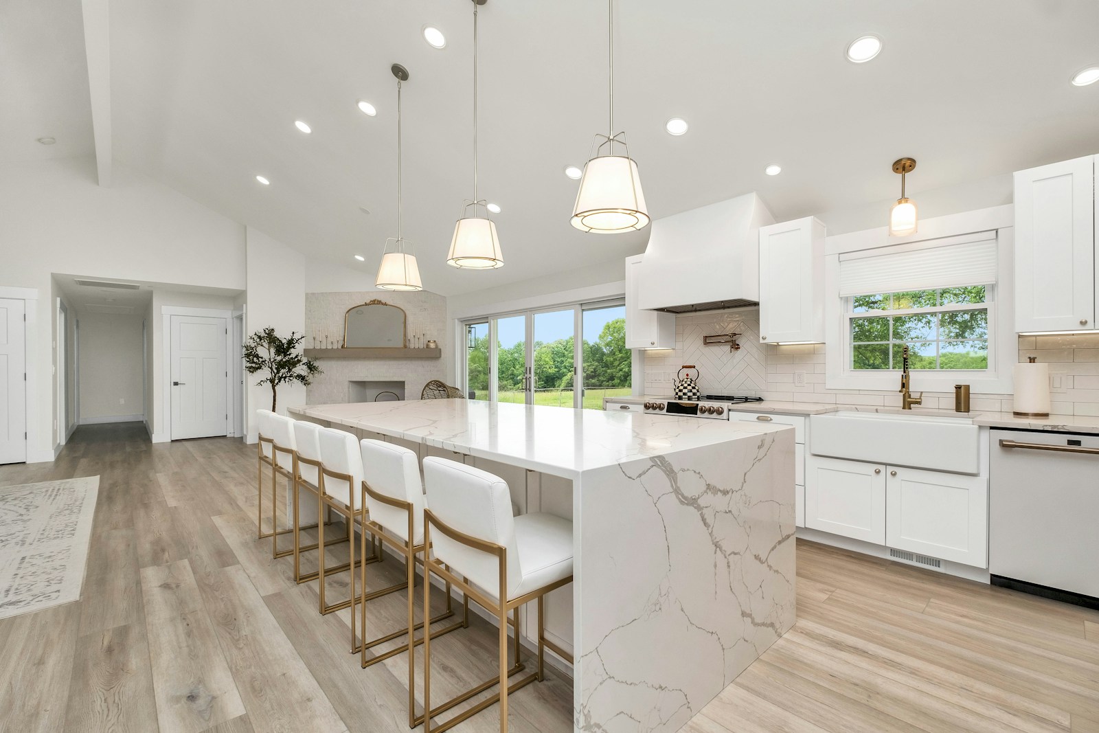 Large marble waterfall island with seating in a modern ranch kitchen